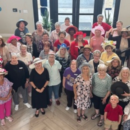 a group of people standing in a large room